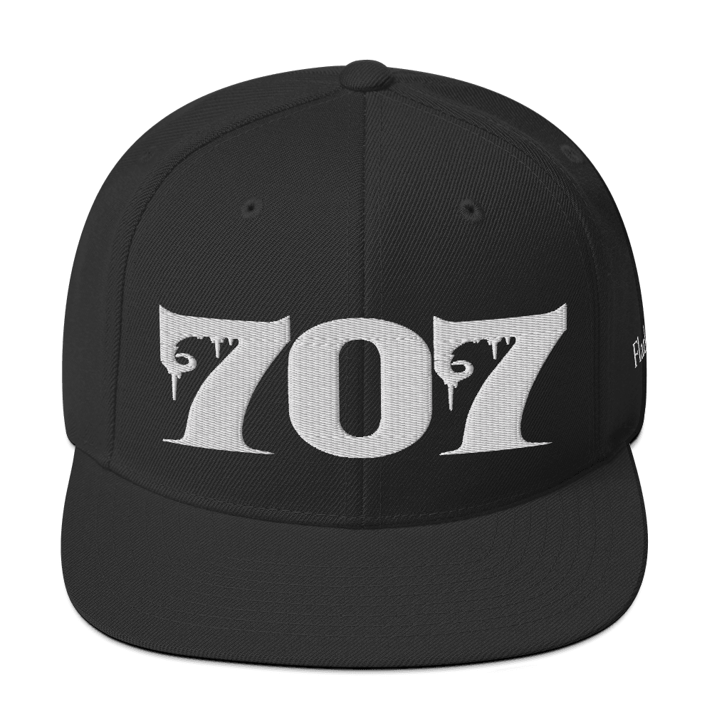 Front view of Deadpan Couture 707 Classic Snapback Hat in black with white gothic-style embroidery.