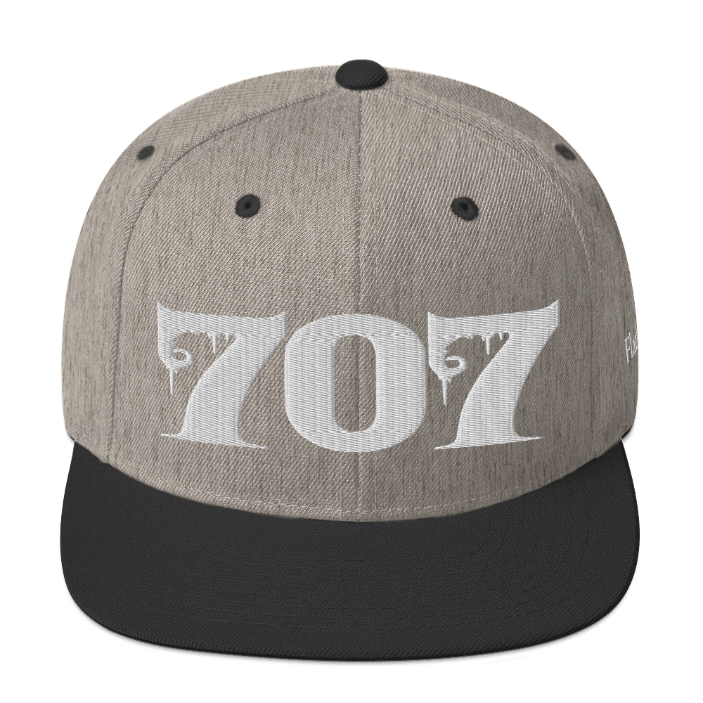 Front view of Deadpan Couture 707 Classic Snapback Hat in black with white gothic-style embroidery.
