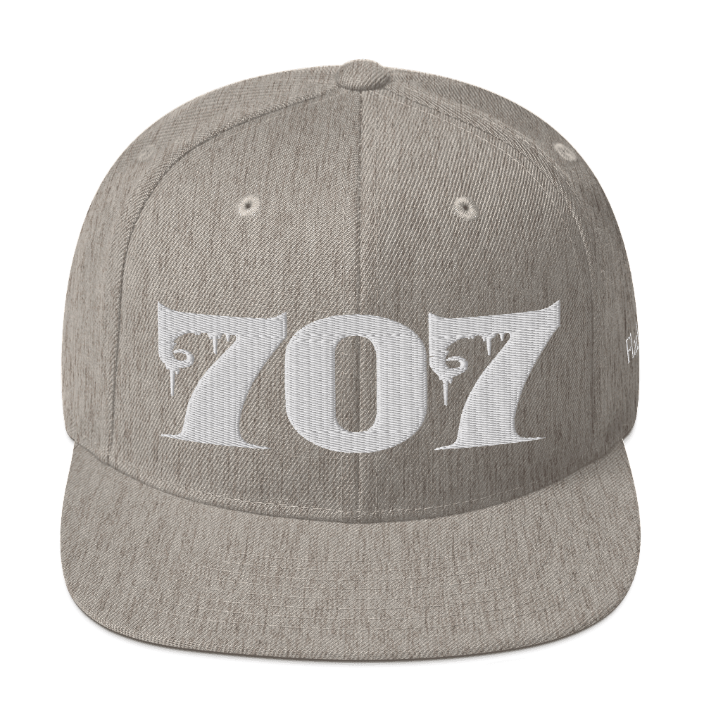 Front view of Deadpan Couture 707 Classic Snapback Hat in black with white gothic-style embroidery.