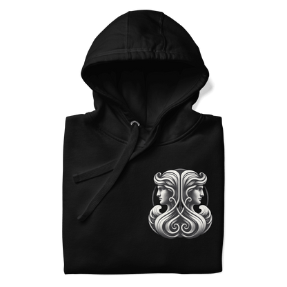 A black unisex premium hoodie featuring an elegant Gemini zodiac design on the front, with twin figures and intricate details.