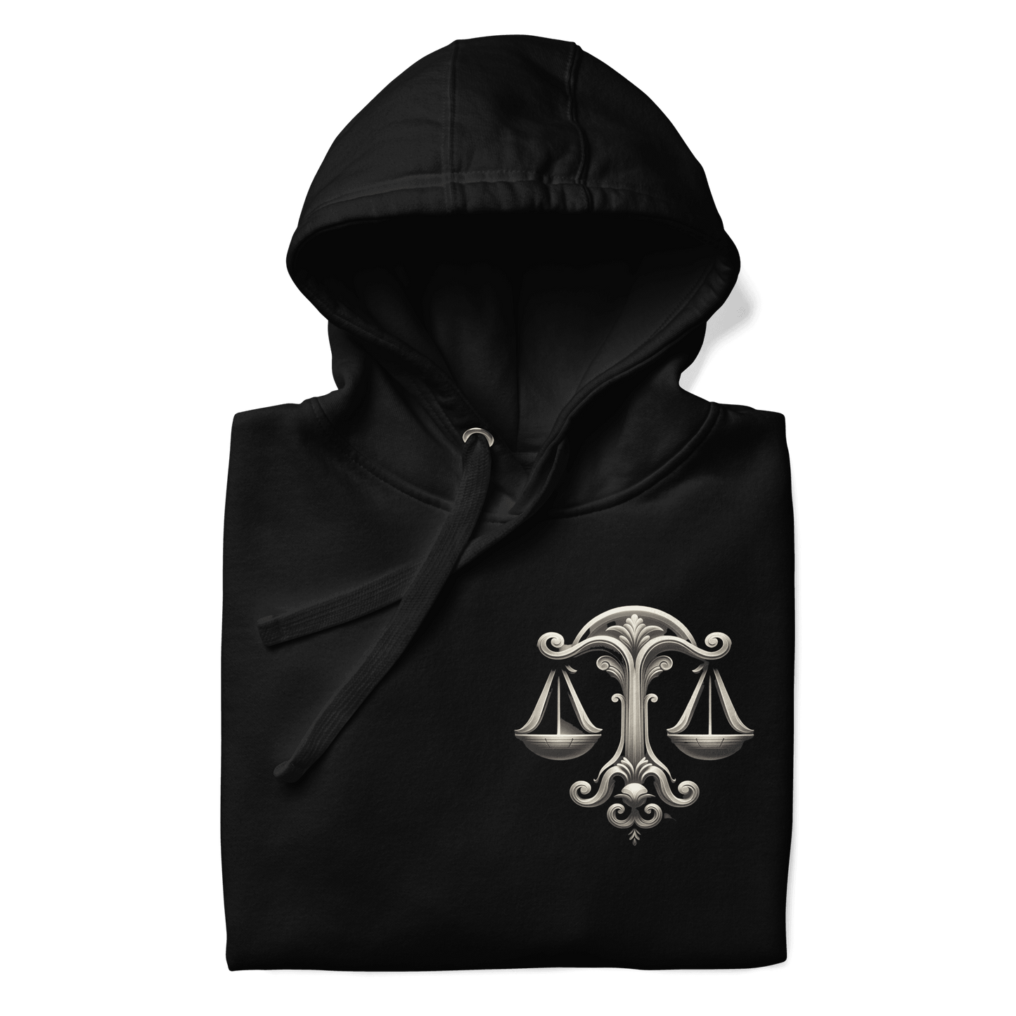 A neatly folded black Deadpan Couture hoodie showcasing the detailed design on the left chest area. The graphic features an ornate set of scales, symbolizing the Libra zodiac sign. The intricate design contrasts beautifully with the black fabric, making the hoodie visually appealing even when folded.