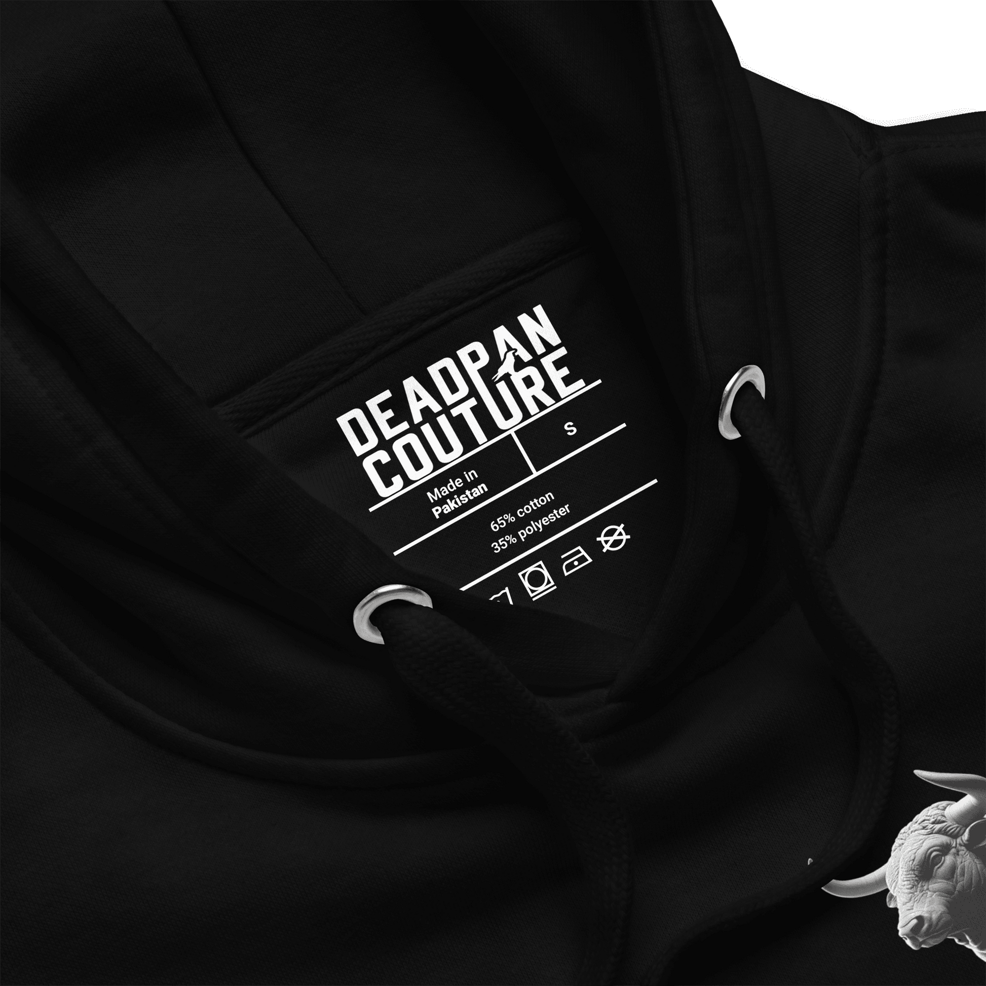 Close-up view of the Deadpan Couture logo inside the hood of the black Taurus Hoodie.