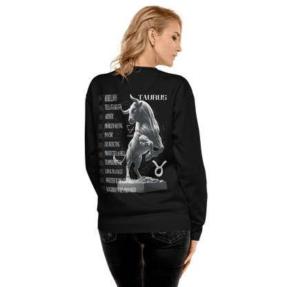 A woman with blonde hair, viewed from the back, is wearing the same black Deadpan Couture sweatshirt. The back shows the same intricate Taurus bull statue and a list of Taurus attributes.