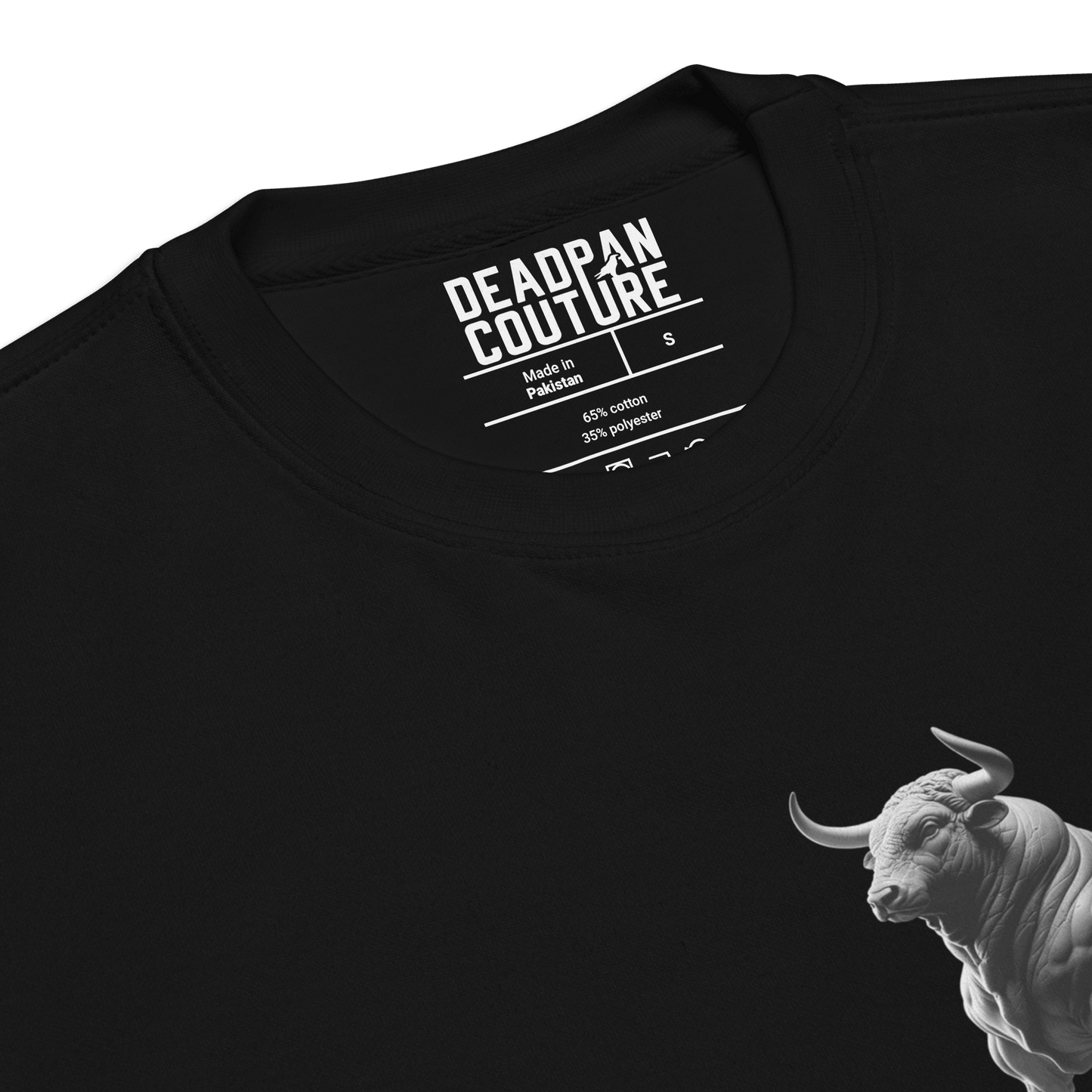 A close-up view of the black Deadpan Couture sweatshirt, focusing on the neckline area. The inner label indicates the brand name, sizing, and fabric composition (65% cotton, 35% polyester).